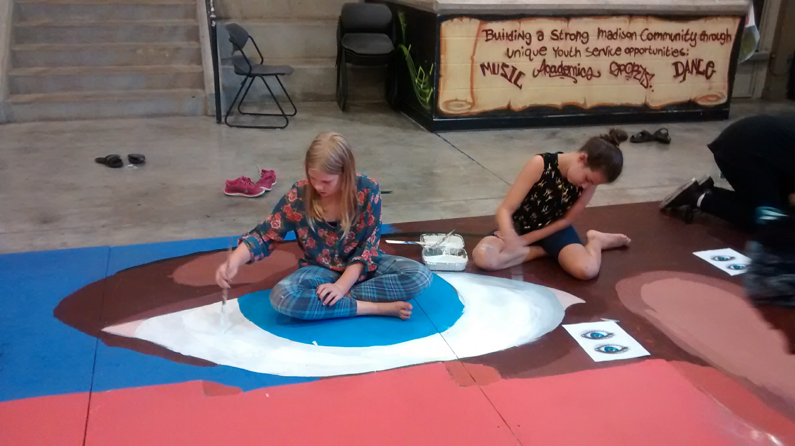 Children Painting Eyes of Wall Mural