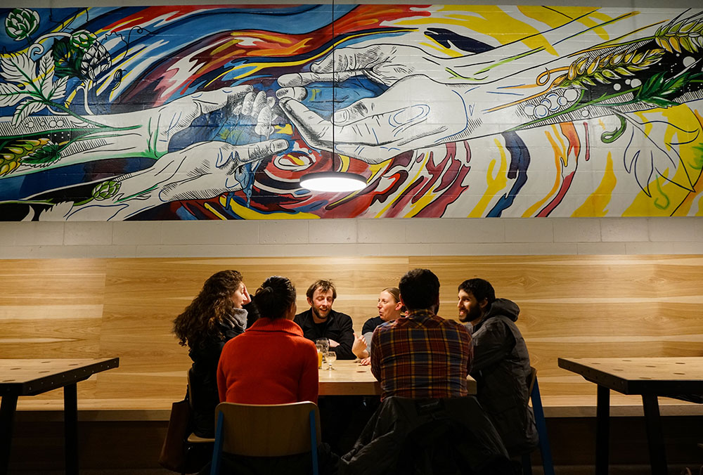 Friends Gathering at Craft Brewery with Mural