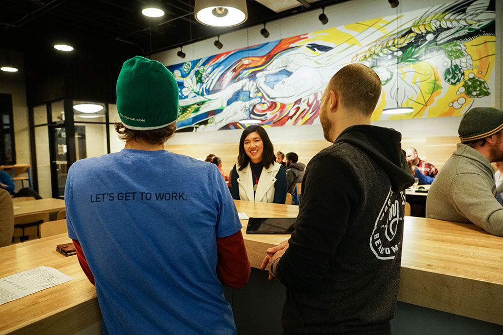 Interaction at Craft Brewery in Front of Mural