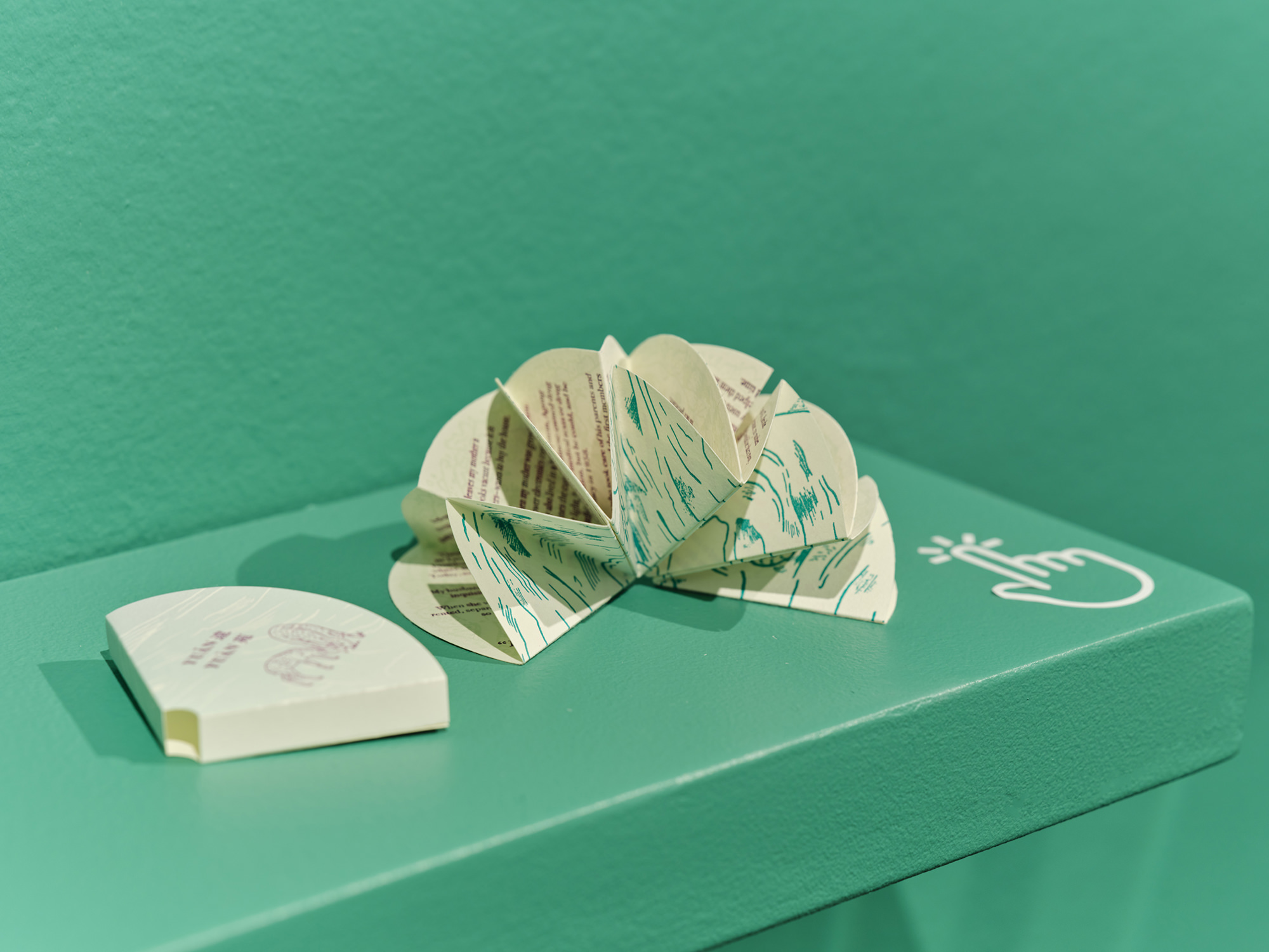 Cover sleeve for artist's book, plus artist's book fanned open resembling flower